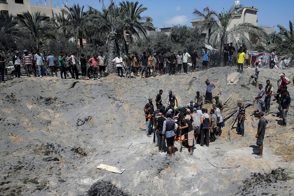 Palestinians retrieving bodies of martyrs killed during a brutal Israeli airstrike targeting refugee camps at Khan Younis, southern Gaza Strip, July 13, 2024. (AP)