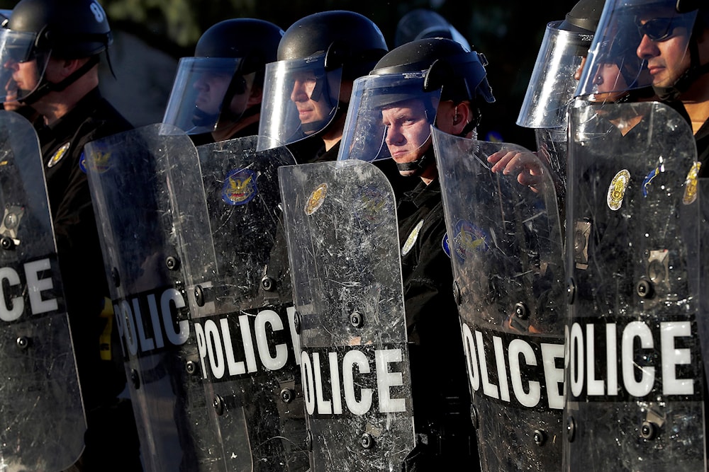 Phoenix Police officers watch protesters rally on June 2, 2020, in Phoenix, during demonstrations over the death of George Floyd. (AP)