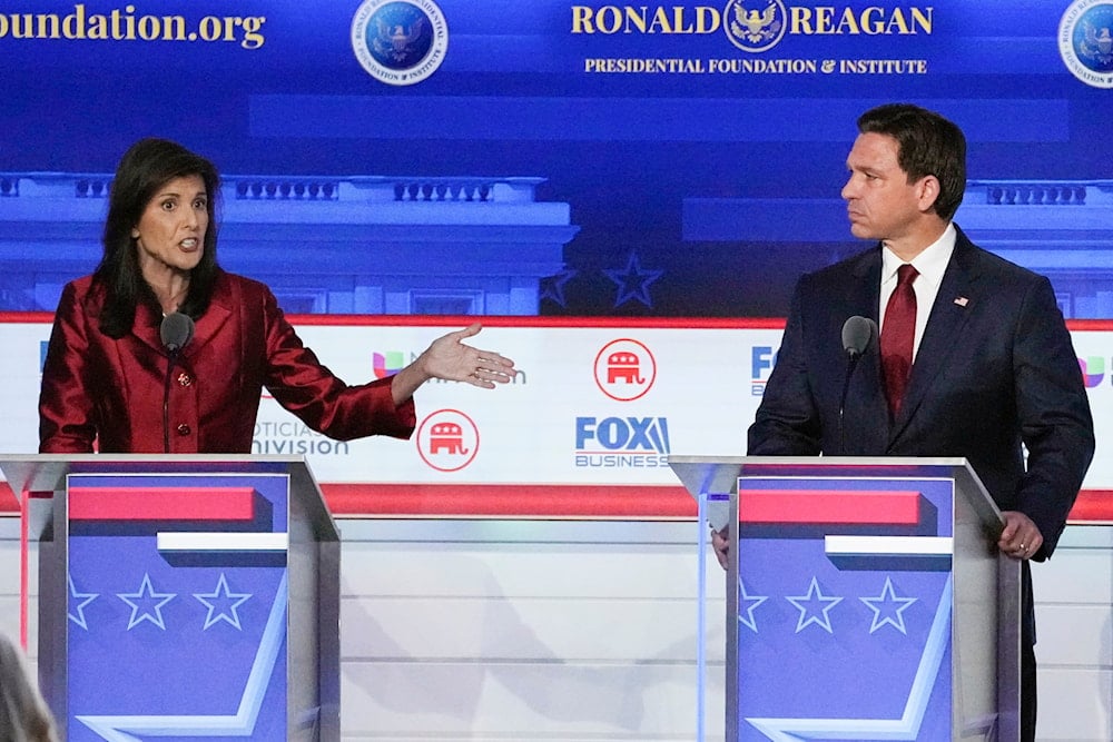 former U.N. Ambassador Nikki Haley, left, with Florida Gov. Ron DeSantis, speaks during a Republican presidential primary debate hosted by FOX Business Network and Univision, Sept. 27, 2023 (AP)