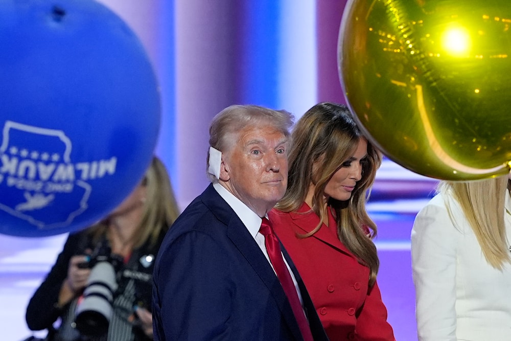 Republican presidential candidate former President Donald Trump, walking on stage with former first lady Melania Trump at the end of the Republican National Convention (RNC), July 18, 2024, in Milwaukee (AP)