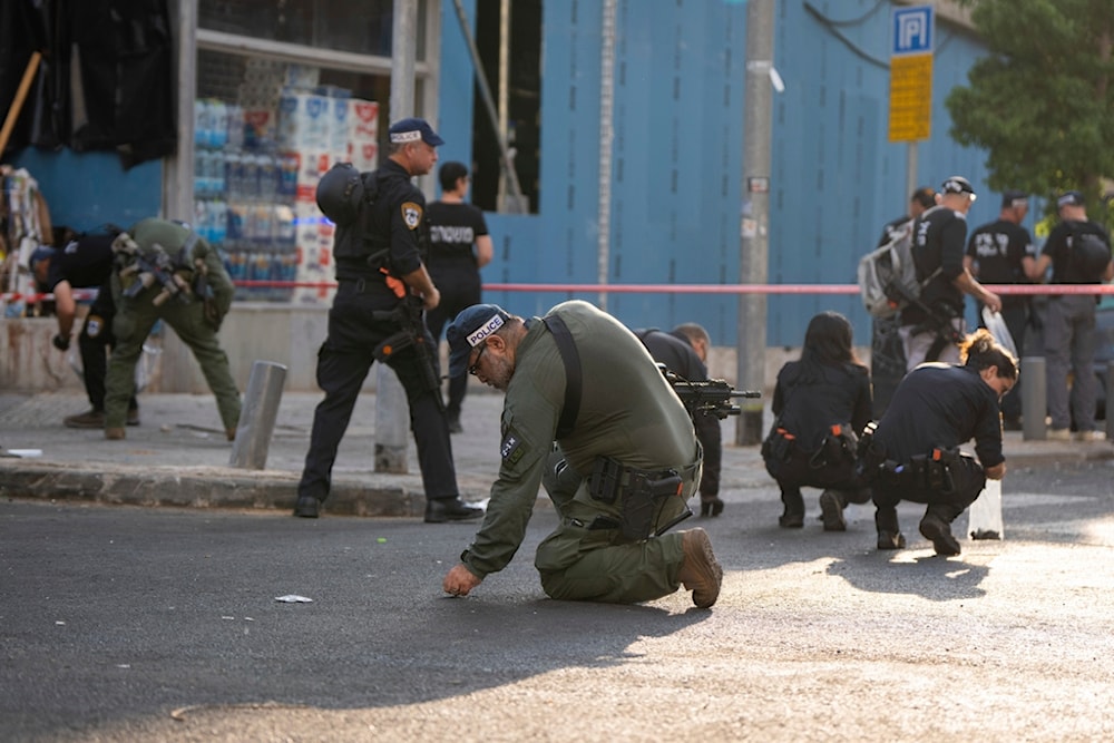 Israeli occupation police investigate the scene of an explosive drone attack in Tel Aviv, occupied Palestine, Friday, July 19, 2024. (AP)