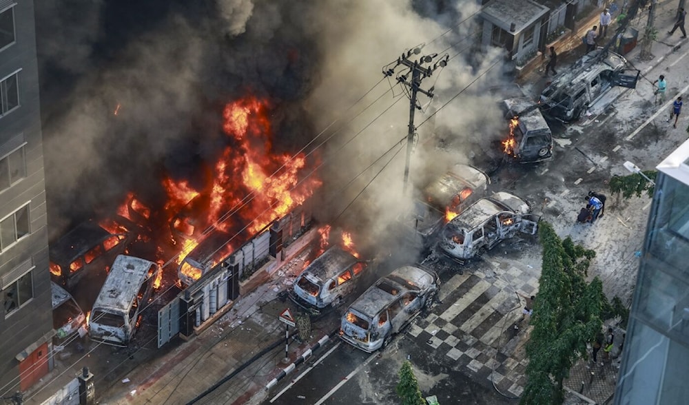 Smoke rises from the burning vehicles after protesters set them on fire during protests in Dhaka on July 18, 2024. (AFP)