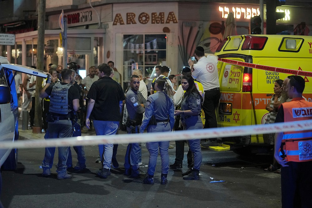 Israeli occupation forces and first responders gather at the scene of a deadly explosion in Tel Aviv, occupied Palestine, early Friday, July 19, 2024 (AP)