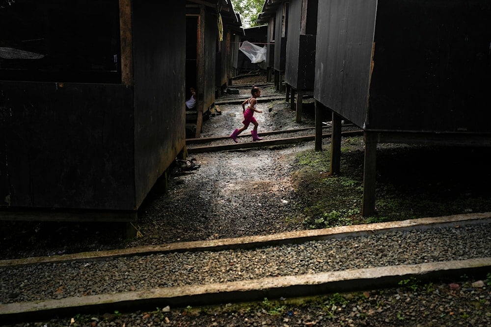 A Venezuelan migrant child runs through a temporary camp after walking across the Darien Gap from Colombia, in Lajas Blancas, Panama, on June 28, 2024. (AP)