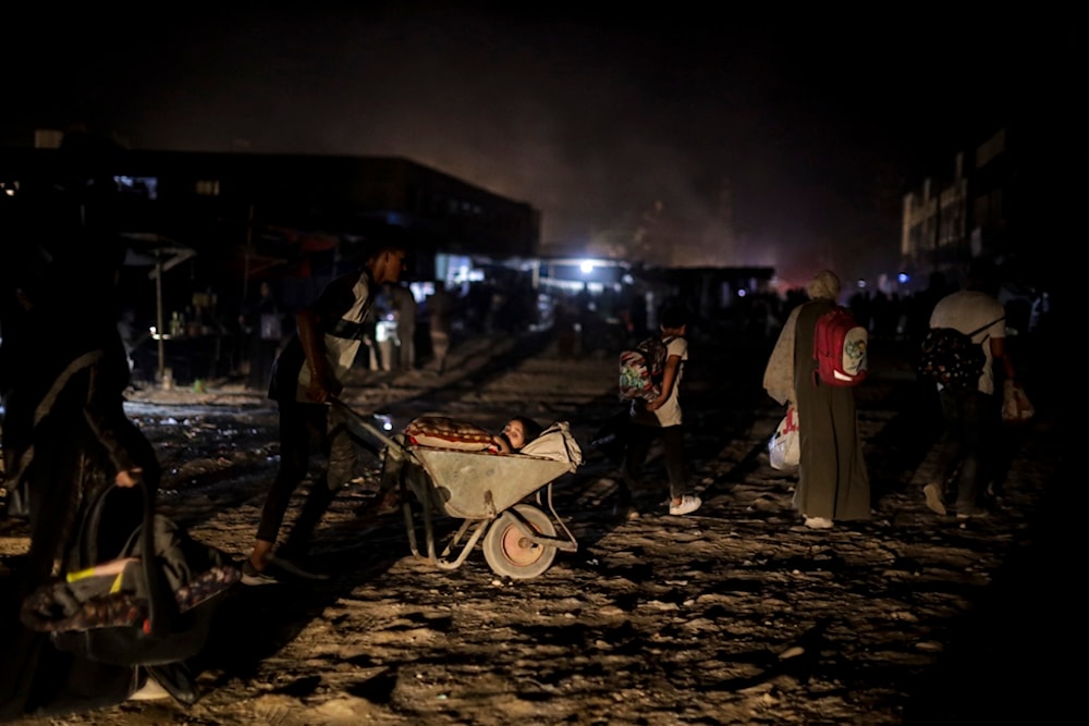 Palestinians displaced by the Israeli genocidal war on the Gaza Strip flee from parts of Khan Younis following an evacuation orders on Monday, July 1, 2024. (AP)