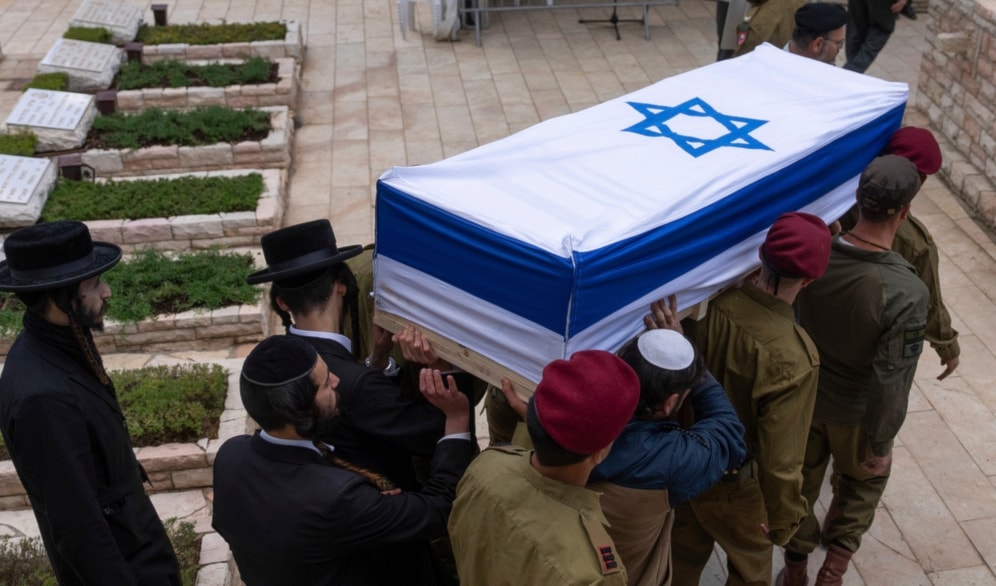 Israeli occupation forces and family members carry the casket of a soldier who died during confrontations a the funeral processions unfold on Tuesday, May 7, 2024. (AP)