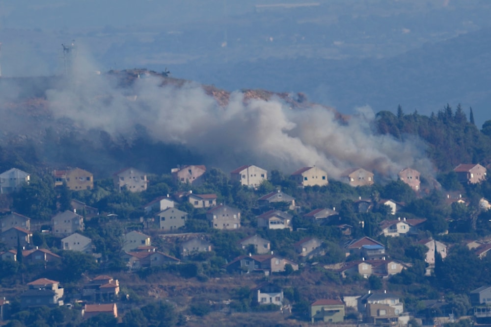 Smoke rise from between the houses of the northern Israeli settlement of Metula which hit by Hezbollah shelling, Lebanon, Saturday, June 22, 2024