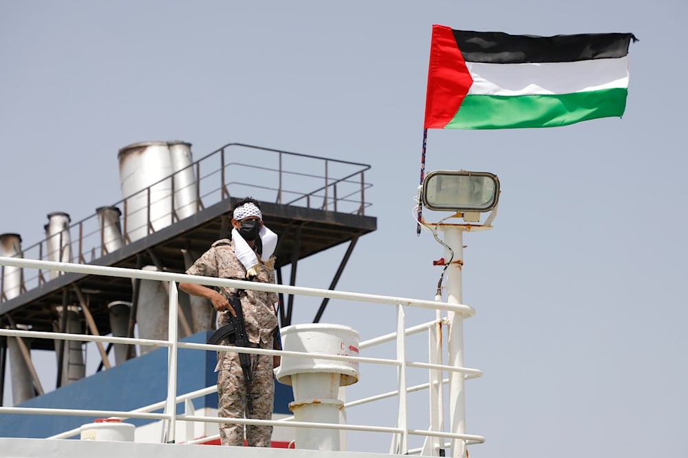 A Yemeni soldier stands on board the Israeli Galaxy ship which was seized by Ansar Allah in the port of Salif, near Hodeidah, Yemen, May 12, 2024 (AP)