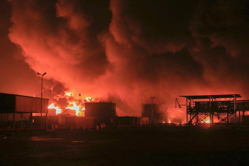 Oil tanks burn at the port in Hodeidah, Yemen, Saturday, July 20, 2024. (AP)