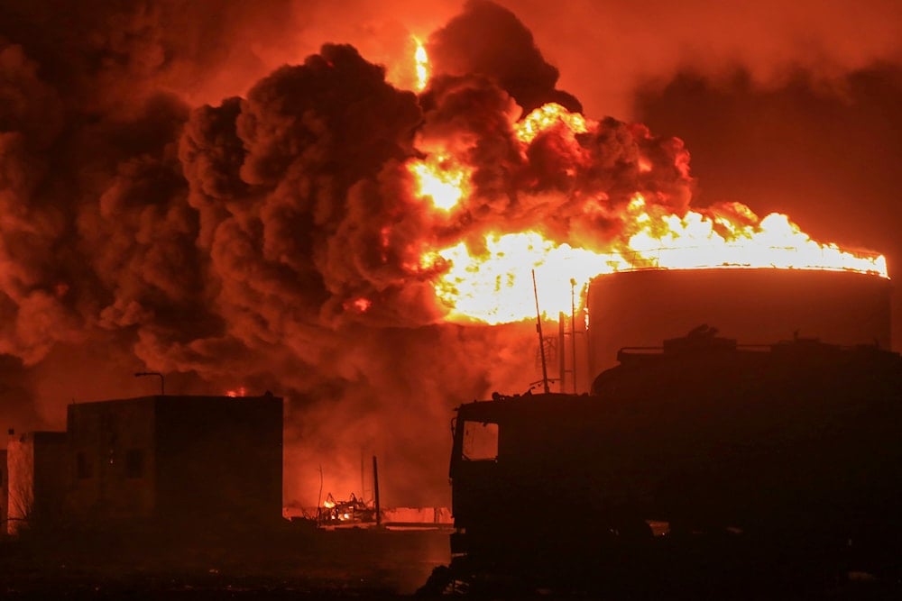 Oil tanks burn at the port in Hodeidah, Yemen, Saturday, July 20, 2024. (AP)