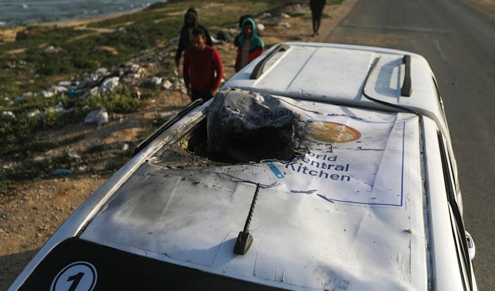 Palestinians inspect a vehicle with the logo of the World Central Kitchen wrecked by an Israeli occupation airstrike in Deir al Balah, Gaza Strip, Palestine, on April 2, 2024. (AP)