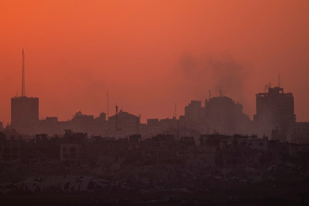 Destroyed buildings stand in the Gaza Strip during the sunset as seen from southern 'Israel', on July 17, 2024. (AP)