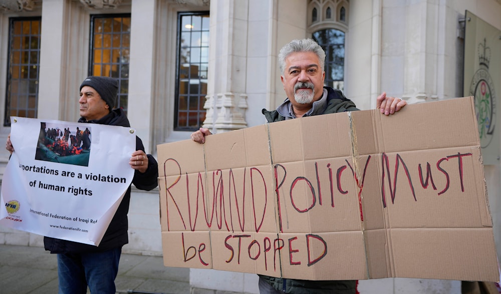 Protesters stand outside the Supreme Court in London, Wednesday, Nov. 15, 2023. (AP)