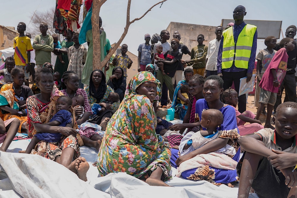 South Sudanese who fled from Sudan sit outside a nutrition clinic at a transit center in Renk, South Sudan, May 16, 2023. (AP)