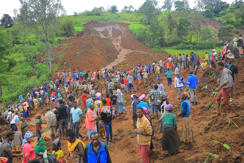 In this handout photo released by Gofa Zone Government Communication Affairs Department, hundreds of people gather at the site of a mudslide in the Kencho Shacha Gozdi district, Gofa Zone, southern Ethiopia, on July 22, 2024. (AP)