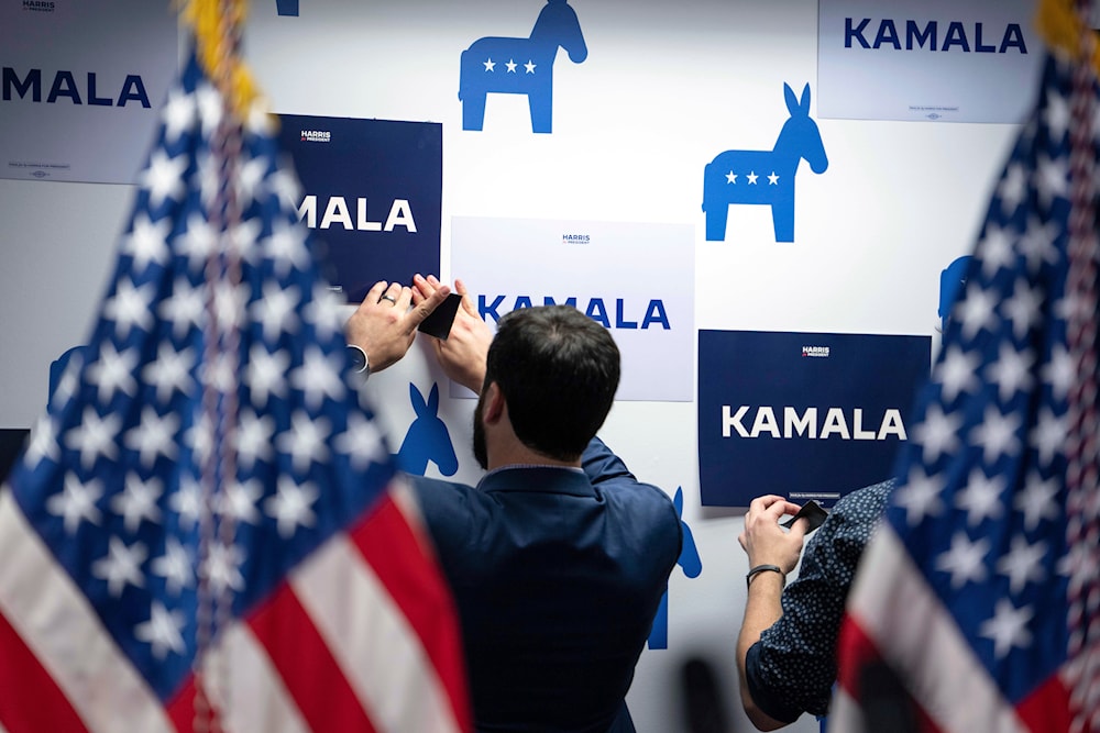 Campaign staff put up signs at Vice President Kamala Harris' campaign headquarters in Wilmington, Del., Monday, July 22, 2024. (Pool/AP)