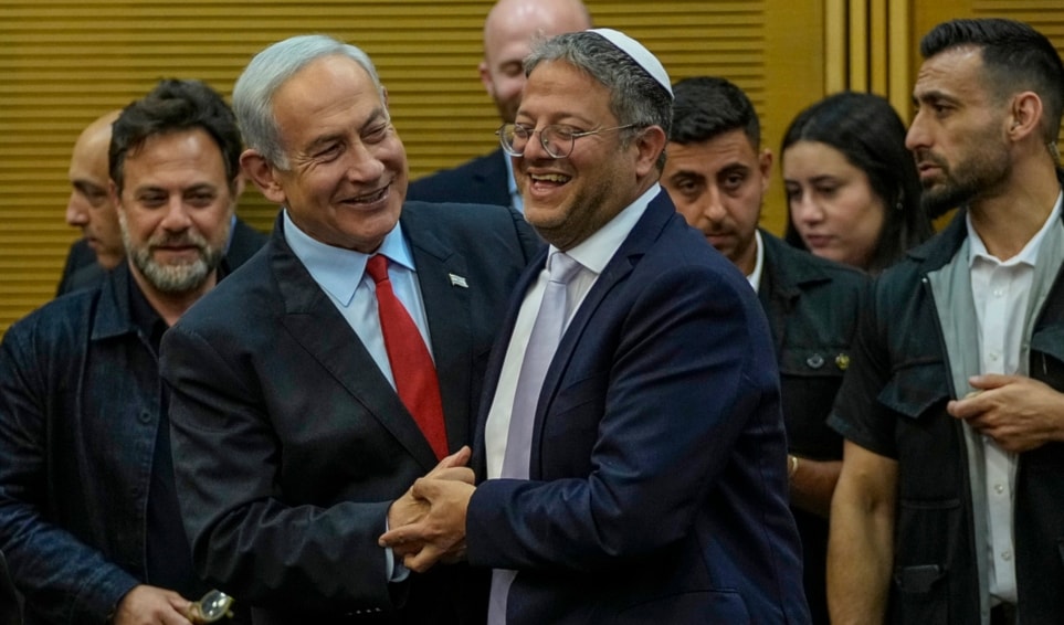 Israeli occupation Prime Minister Benjamin Netanyahu and Police Minister Itamar Ben-Gvir smile before Netanyahu's statement in the Knesset, in occupied al-Quds, May 23, 2023. (AP)