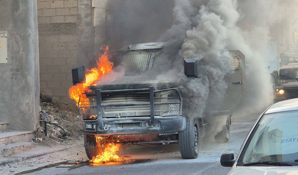 An Israeli occupation vehicle catches fire after being targeted with Molotov cocktails during a raid into the town of Artas, near Beit Lahm, West Bank, occupied Palestine. (Al-Quds News/Social media)