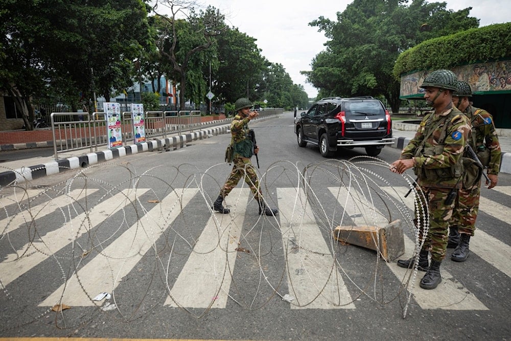 Bangladeshi military forces soldiers put up barbed wires on a main street in Dhaka, Bangladesh, Monday, July 22, 2024. (AP)