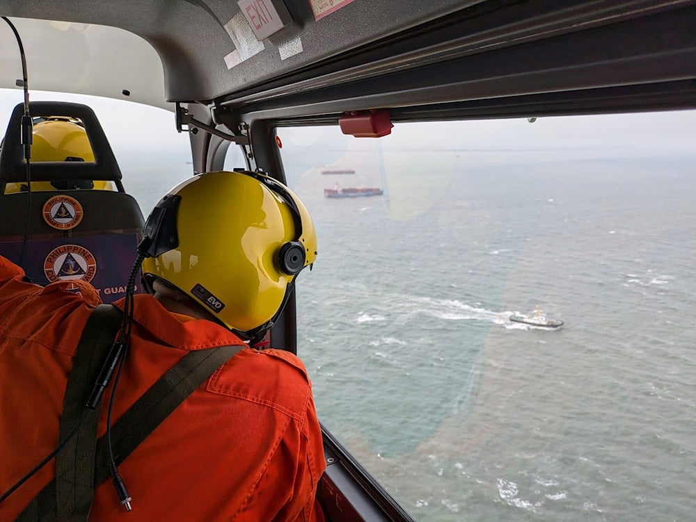 In this photo provided by the Philippine Coast Guard, an aerial survey is conducted by Coast Guard Aviation Command as part of the oil spill response operation in Manila Bay, Philippines, July 25, 2024 (AP)