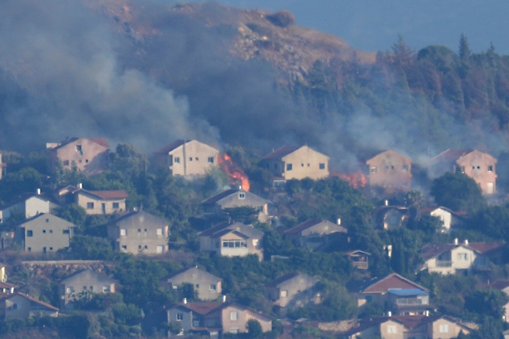 Fires and smoke rise at houses in the northern border settlement of Metula, hit by Hezbollah shelling, as seen from the Lebanese town of Marjayoun, Lebanon, Saturday, June 22, 2024. (AP)