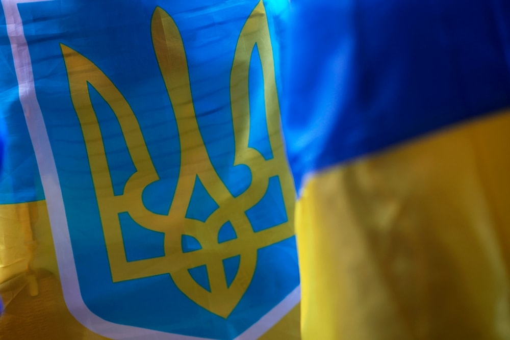 Demonstrators hold Ukrainian flags during a protest against the war outside the Russian embassy in Lisbon, Thursday, July 11, 2024. (AP)