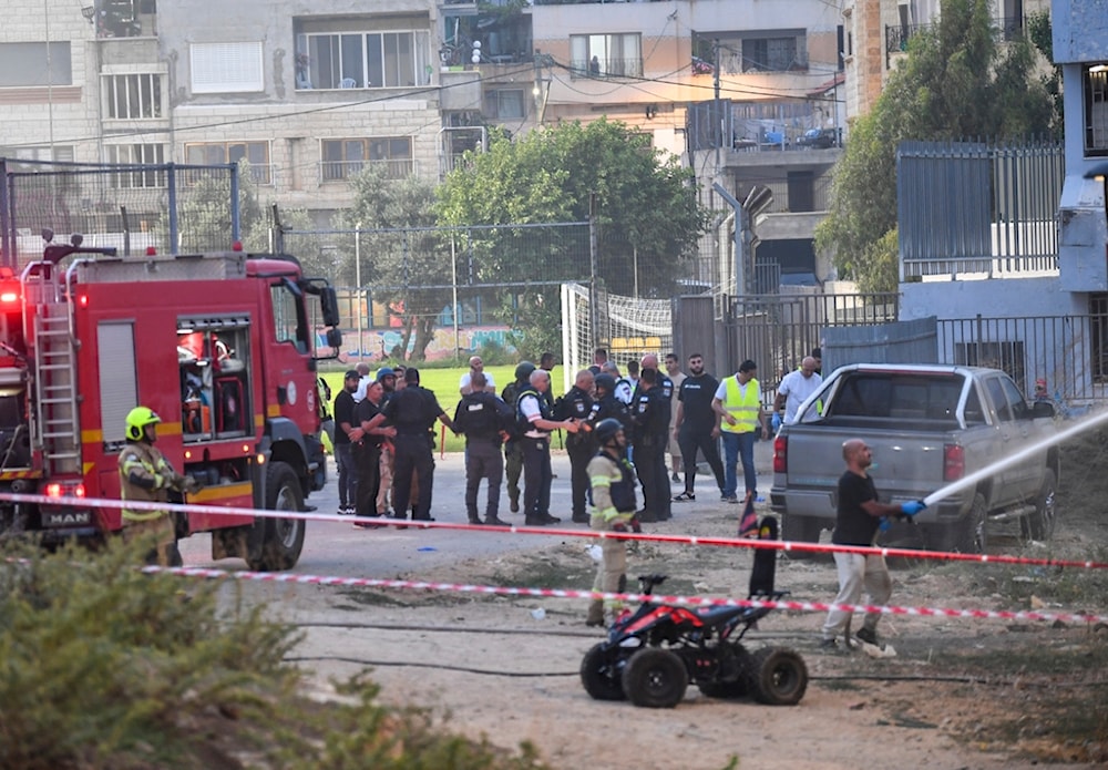 Israeli police officers and firefighters work at the site of a rocket attack in Majdal Shams, in the occupied Golan Heights, Saturday, July 27, 2024. (AP Photo/Gil Eliyahu)