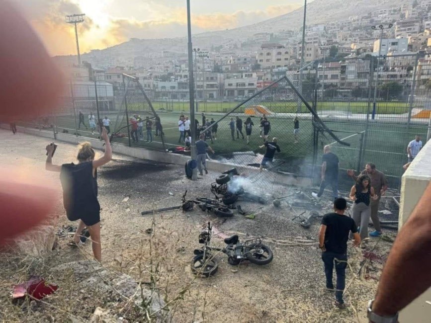 People rush to the site struck by a missile of unknown origin in the occupied Syrian Golan, Syria, July 27, 2024 (Social media)