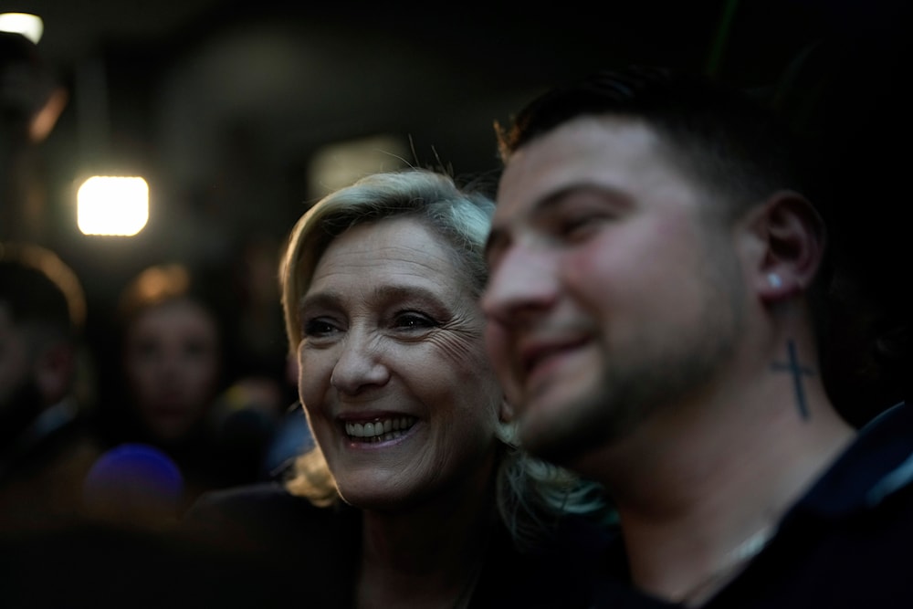 French far right leader Marine Le Pen poses for a selfie on Sunday, June 30, 2024 in Henin-Beaumont, northern France. (AP)