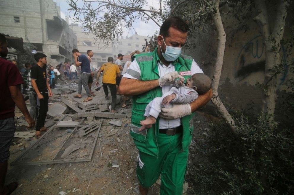 Palestinian medic takes a baby pulled out of buildings destroyed in the Israeli bombardment of the Gaza Strip in Rafah, Oct. 22, 2023. (AP)