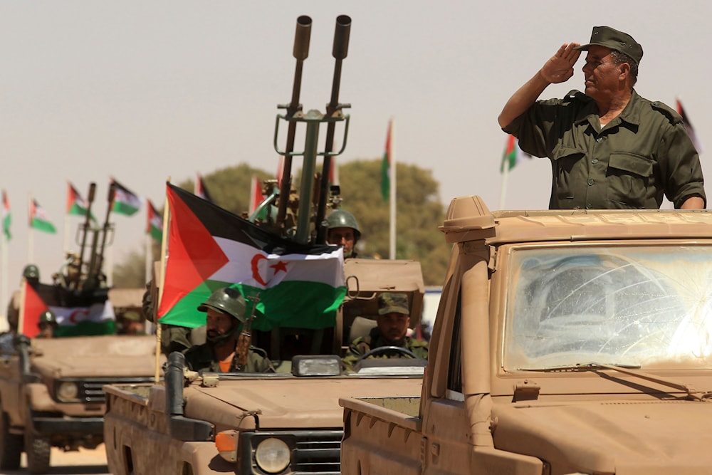 A Polisario Front soldier salutes during a military parade to celebrate the 50th anniversary of the Polisario Front in the Aoussered camp, Algeria, Saturday, May 20, 2023. (AP)