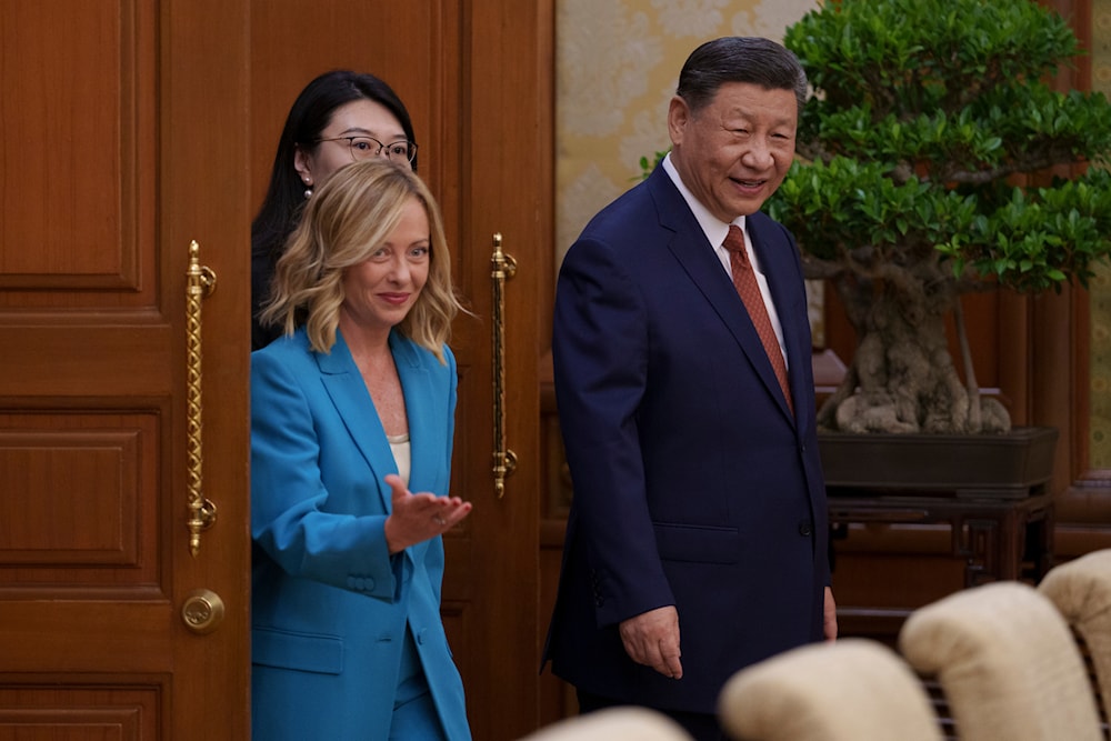 Chinese President Xi Jinping, right, walks with Italian Premier Giorgia Meloni, left, for a meeting at the Diaoyutai State Guesthouse in Beijing, China, on July 29, 2024. (AP)