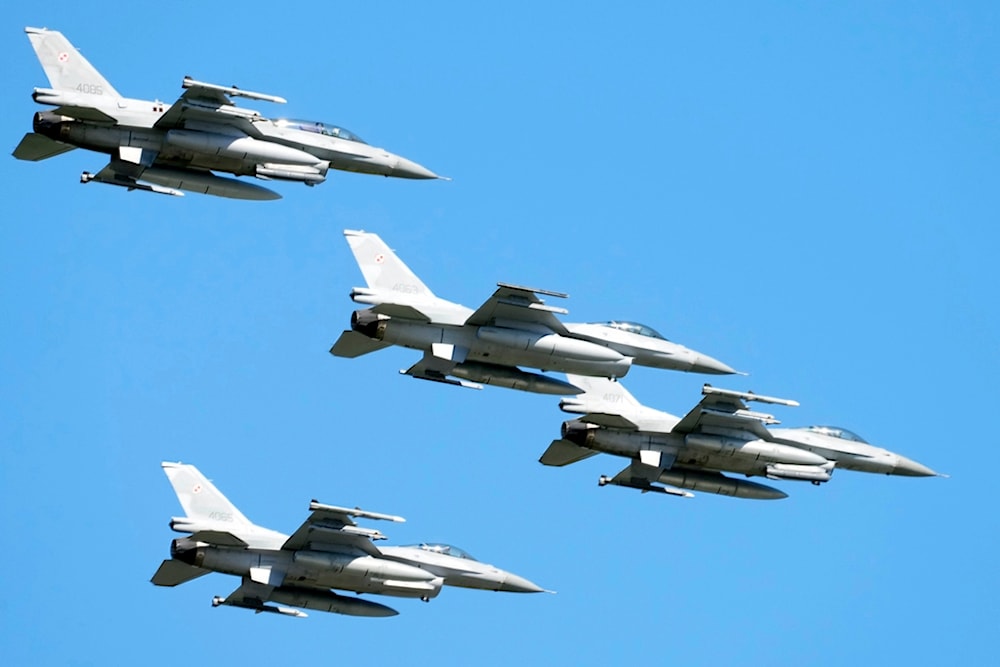 U.S. made F-16 fighter jets fly in the sky over Poland's capital as they take part in a massive military parade to celebrate the Polish Army Day, in Warsaw, Poland, Aug. 15, 2023. (AP)