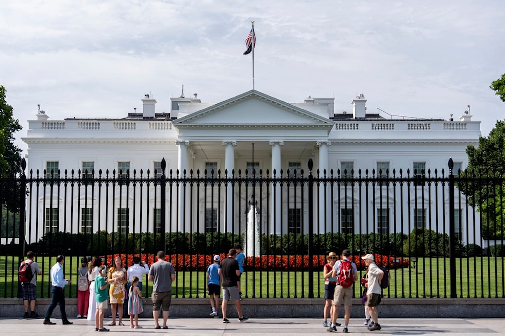 Visitors stand outside the White House, Tuesday, July 23, 2024, in Washington. (AP Photo/Julia Nikhinson)