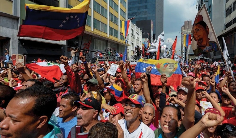 Supporters of Venezuelan President Nicolas Maduro take part in a rally against the secretary general of the Organization of American States (OAS), Luis Almagro, in Caracas on March 28, 2017. (AFP)