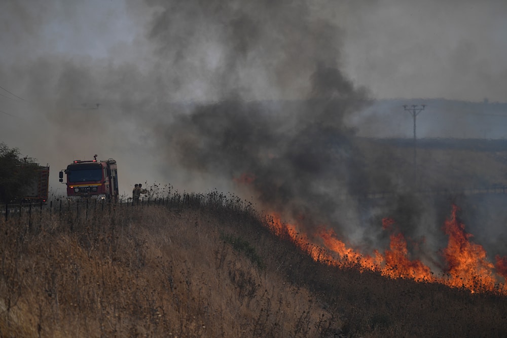 Israeli firefighters work to extinguish a fire following an attack from the Islamic Resistance in Lebanon - Hezbollah, in an area in the occupied Golan Heights, July 4, 2024 (AP) 