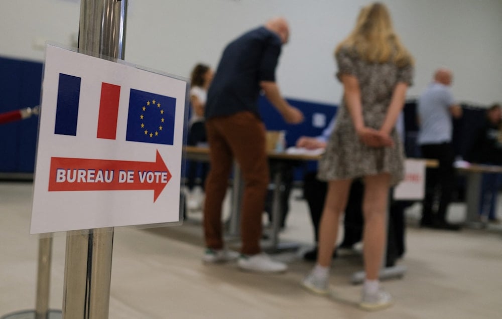 French nationals vote at the Lycée Français de Los Angeles during the first round of French legislative elections, in Los Angeles, on June 29, 2024. (AFP)