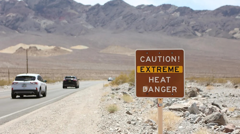 A sign raised across the Southwest, Northeast, and Midwest to caution from extreme heat danger. (AFP VIA GETTY IMAGES)