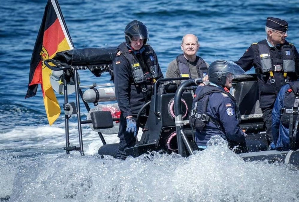 German Chancellor Olaf Scholz, second from left, rides on a boat to the frigate Mecklenburg-Vorpommern on June 5, 2023. (AFP via Getty Images)