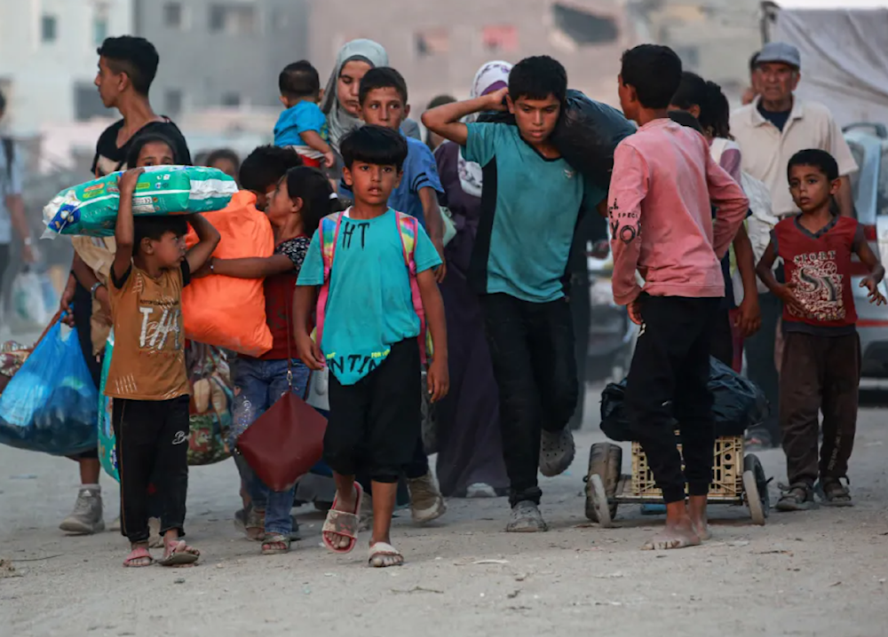 Displaced Palestinians leave an area of east Khan Younis after the Israeli army issued an evacuation order for parts of the city and Rafah. (AFP)