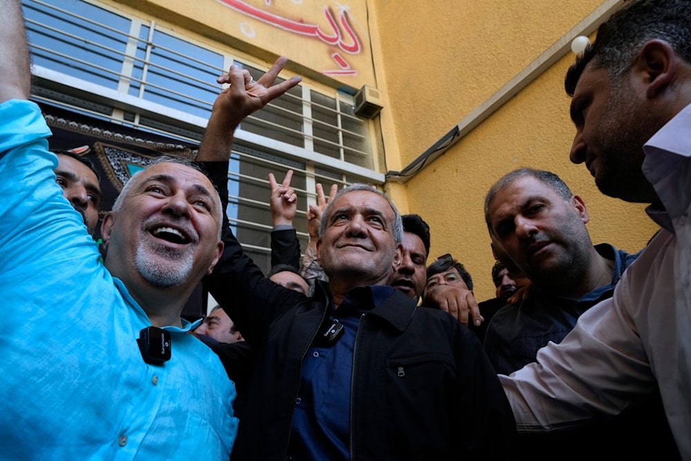 Iran's presidential election winner Masoud Pezeshkian accompanied by former Foreign Minister Mohammad Javad Zarif at a polling station in Shahr-e-Qods near Tehran, Iran, Friday, July 5, 2024. (AP)