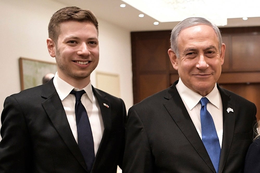 Israeli Prime Minister Benjamin Netanyahu, second from left, and son Yair, left, pose for a photo in Tel Aviv, occupied Palestine, January 23, 2020 (AP)