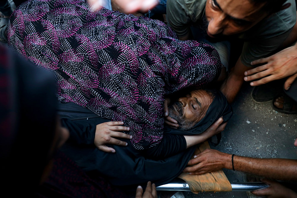 Relatives mourn over the body of a Palestinian man killed in an Israeli airstrike on a U.N.-run school that killed dozens of people in the Nusseirat refugee camp in the Gaza Strip, Saturday, July 6, 2024. (AP)