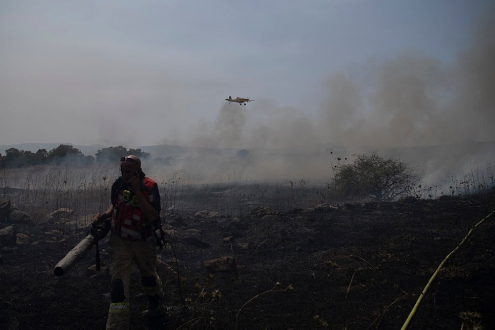 A firefighter works to extinguish a fire following an attack from the Lebanese Hezbollah Resistance group in the occupied Golan Heights, on Thursday, July 4, 2024. (AP)