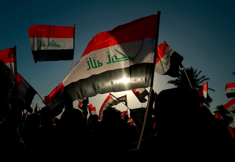 Iraqis chant during a rally before the parliamentary elections in Baghdad, Iraq, October 7, 2021 (AP)