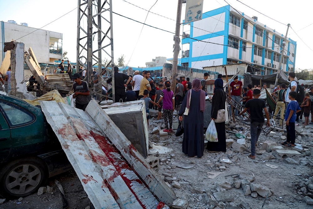 Blood can be seen in the aftermath of the Israeli occupation airstrike on a UN-run school that killed dozens of Palestinians in the Nusseirat refugee camp in the Gaza Strip, July 6, 2024. (AP)