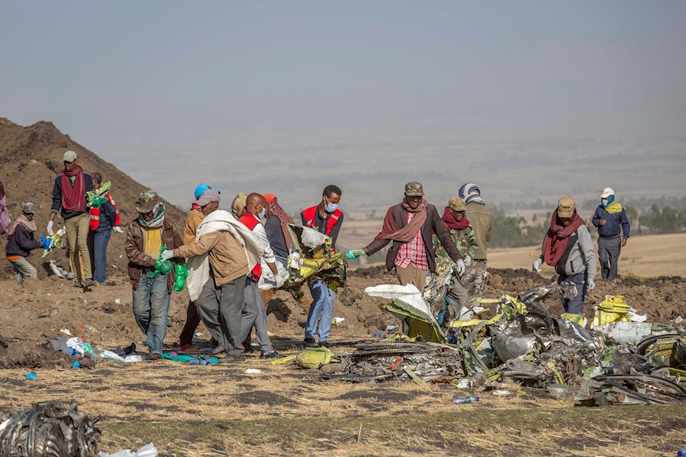 Rescuers work at the scene of an Ethiopian Airlines Boeing Max crash near Bishoftu, or Debre Zeit, south of Addis Ababa, Ethiopia, on March 11, 2019 (AP)