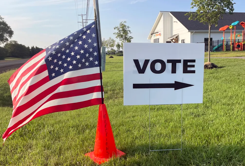 n American flag waves in the breeze next to a sign directing Ohioans to vote inside Tharp Sixth Grade School, Tuesday, Aug. 8, 2023 in Hilliard, Ohio