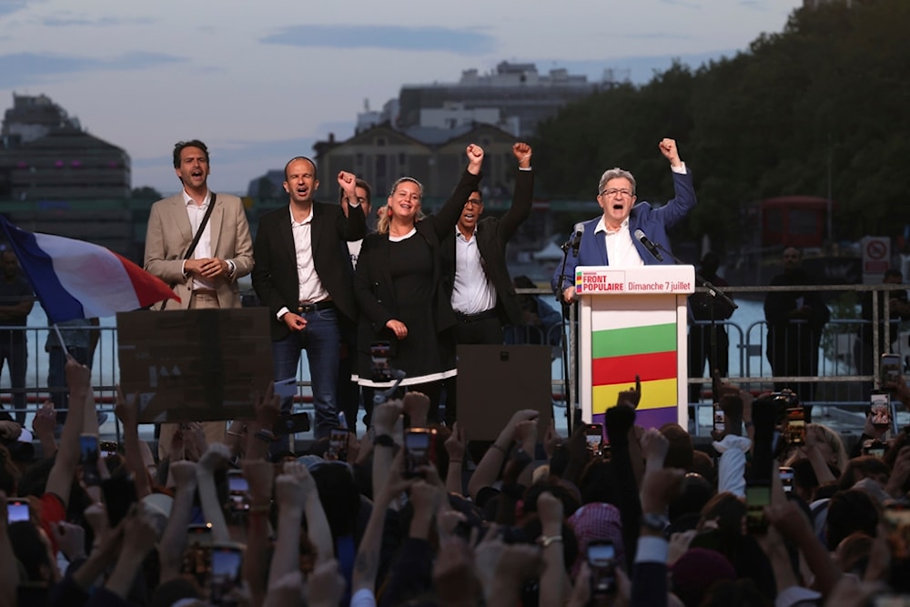 LFI founder Jean-Luc Melenchon, right, clenches his fist with other party members after the second round of the legislative elections Sunday, July 7, 2024, in Paris. (AP)