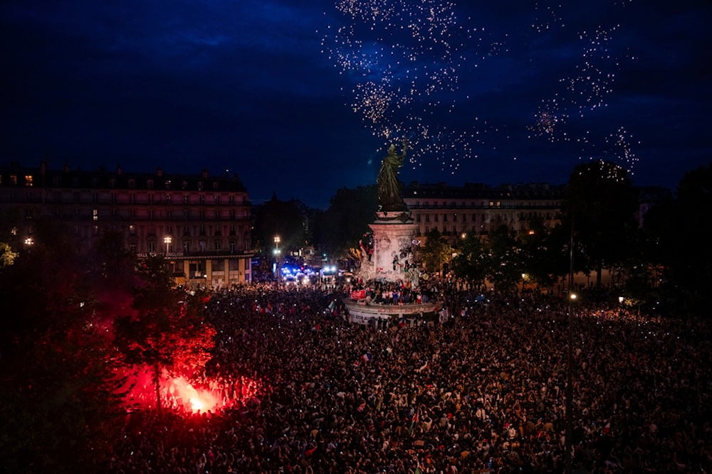 People gather at the Republique plaza after the second round of the legislative election, Sunday, July 7, 2024 in Paris. (AP)